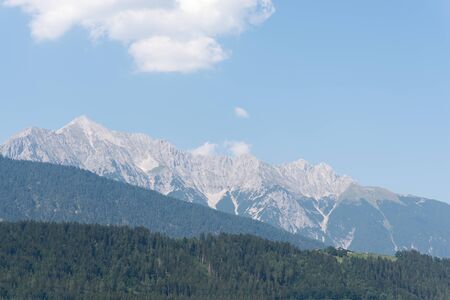 Beautiful mountain view with blue sky and green hillsの写真素材