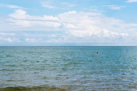 Sea view with skyline and blue sky with cloudsの写真素材