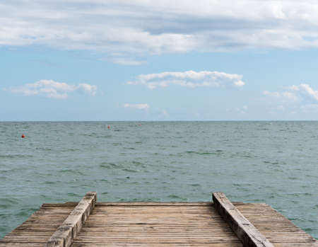 Sea view with quay and blue sky with cloudsの写真素材