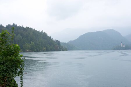 Landscape view with lake and hills on blue skyの写真素材