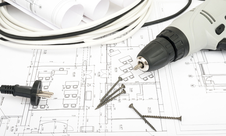 Architecture plan and rolls of blueprints with cabel and electric screwdriver. Building conceptの写真素材