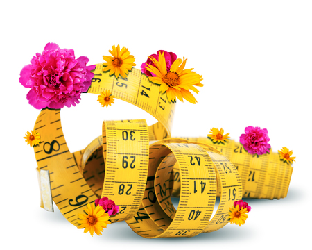 Measuring tape with flowers isolated on white backgroundの写真素材