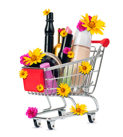 Cosmetics in shopping cart with flowers isolated on white backgroundの写真素材