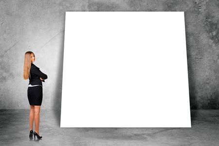 Big blank banner with businesswoman on grey wall backgroundの写真素材