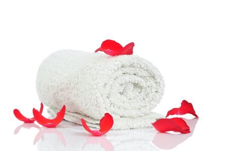 White towel and red rose petals isolated on white background の写真素材