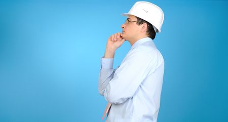 An engineer with white hard hat on blue backgroundの写真素材