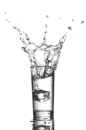 Water splashes in the glass on white backgroundの写真素材
