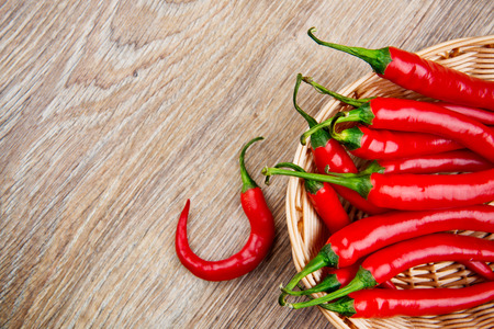 Organic chili peppers on wooden backgroundの写真素材