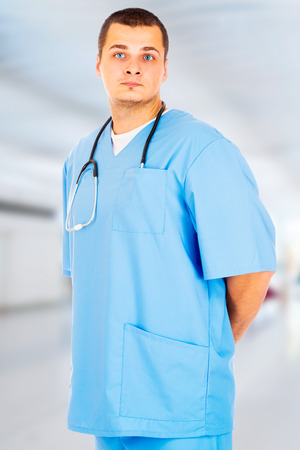 Male Doctor stands in the hall of the hospitalの写真素材