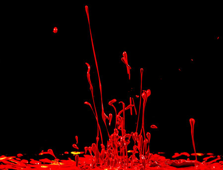 Red paints plash on black background