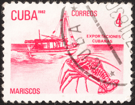 MOSCOW, RUSSIA - JANUARY, 2016: a post stamp printed in CUBA shows a boat and a lobster (Mariscos), the series "Exports", circa 1982のeditorial素材