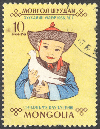 MOSCOW, RUSSIA - CIRCA JANUARY, 2016: a post stamp printed in MONGOLIA shows a child and a dove, the series "Children's Day", circa 1966のeditorial素材