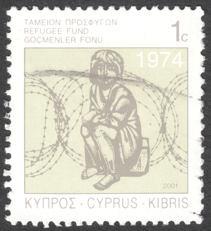 MOSCOW, RUSSIA - CIRCA JANUARY, 2016: a post stamp printed in CYPRUS shows a child and barbed wire, circa 2001のeditorial素材
