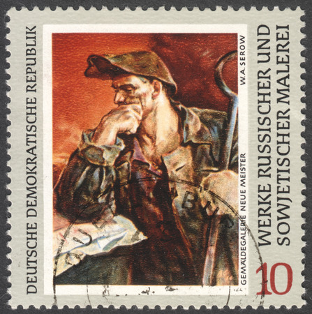 MOSCOW, RUSSIA - CIRCA FEBRUARY, 2016: a stamp printed in DDR shows a painting "Steel-worker" by Serov, the series "Russian Paintings" circa 1969のeditorial素材