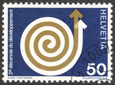 MOSCOW, RUSSIA - CIRCA APRIL, 2016: a post stamp printed in SWITZERLAND shows a rising spiral, devoted to Development Aid, circa 1971のeditorial素材