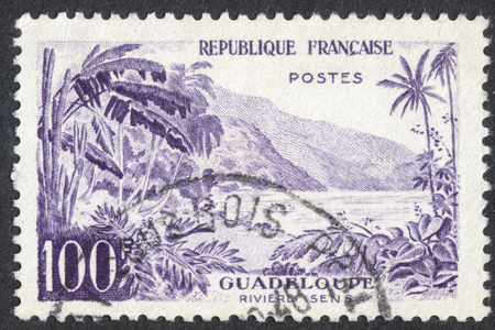 MOSCOW, RUSSIA - CIRCA AUGUST, 2016: a stamp printed in FRANCE shows view of Sens River, Guadeloupe, the series "Landscapes", circa 1957のeditorial素材