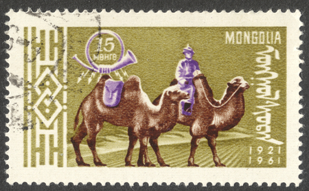 MOSCOW, RUSSIA - CIRCA AUGUST, 2016: a stamp printed in MONGOLIA shows a postman on Bactrian Camel (Camelus bactrianus), the series "The 40th Anniversary of Mongolian Postal Service", circa 1961のeditorial素材