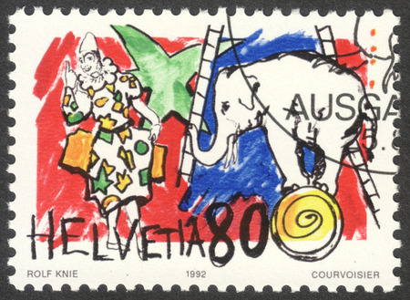 MOSCOW, RUSSIA - CIRCA OCTOBER, 2016: a stamp printed in SWITZERLAND shows Elephant & white clown, the series "Circus", circa 1992のeditorial素材