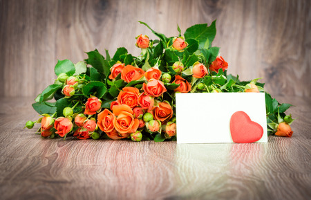 Photo of the bouquet of roses flowers on wooden backgroundの写真素材
