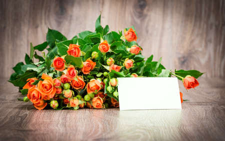 Photo of the bouquet of roses flowers on wooden backgroundの写真素材