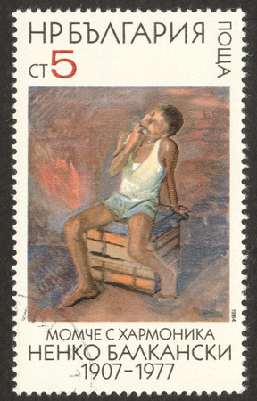MOSCOW RUSSIA - CIRCA DECEMBER 2017: a post stamp printed in BULGARIA shows painting "The Boy with Mouth Organ", the series "Paintings by Nenko Balkanski", circa 1984のeditorial素材
