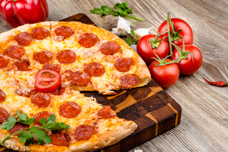 Hot pizza on wooden backgroundの写真素材