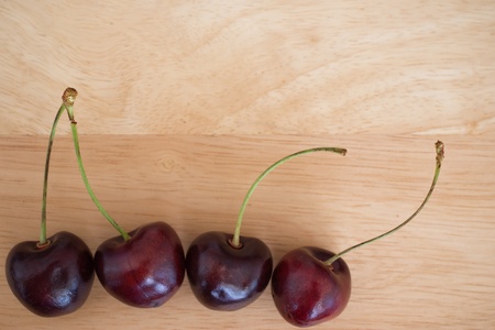 Four cherries on wooden backgroundの写真素材