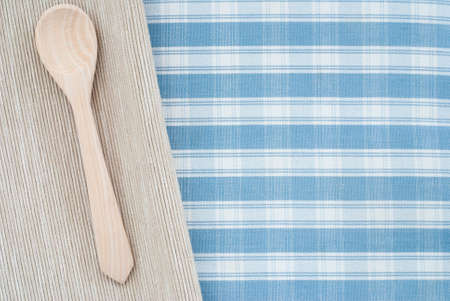 wooden spoon on checkered backgroundの写真素材