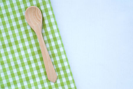 wooden spoon on checkered backgroundの写真素材