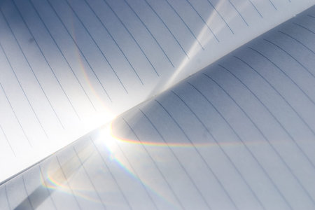 Sun light on a paper notebook