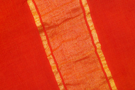 close up of a sari - red silk textile with golden linesの写真素材