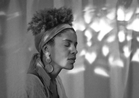 young afro american woman profile with closed eyes - studio shot -  lights and shadows