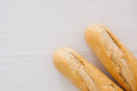 two baguettes on linen background - studio shot - free space for textの写真素材