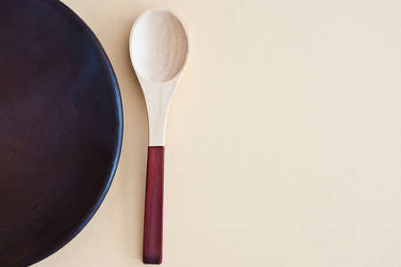 wooden spoon and empty plate from above - studio shotの写真素材