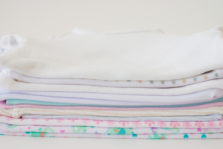 stack of baby clothes - studio shotの写真素材