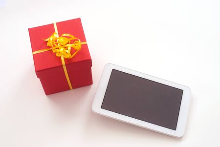 close up of isolated digital Tablet and red christmas gift box - Free text space - studio shotの写真素材
