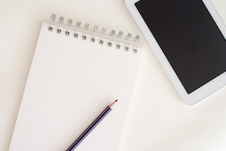 close up of tablet and notebook - modern office workspace - professional desktop from aboveの写真素材