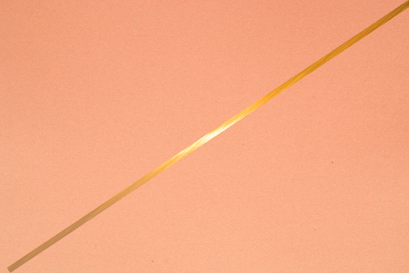golden line on color paper background - abstract graphic designの写真素材