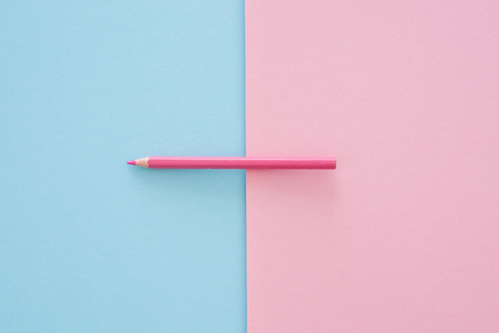 pink pencils on pink and blue paper backgroundの写真素材