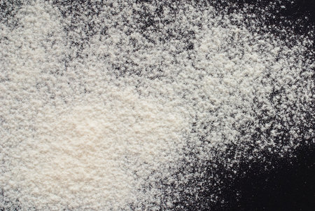 white flour on black background - free space for textの写真素材