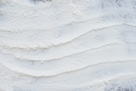 close up of white flour on wooden background