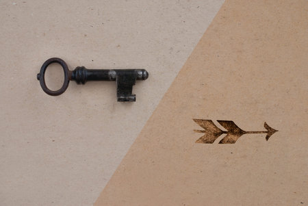 old key and arrow on golden ancient background