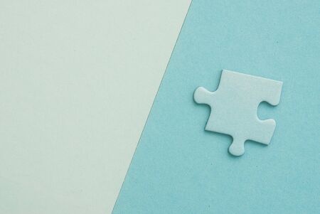 isolated blue Puzzle piece on blue paper backgroundの写真素材