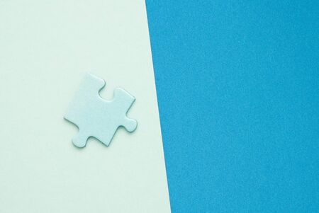 isolated blue Puzzle piece on blue paper backgroundの写真素材