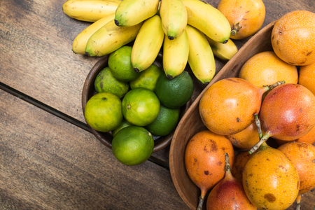 colorful tropical fruits on wooden table - studio shot from aboveの写真素材
