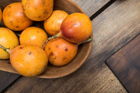 granadilla fruits on wooden background - studio shot from above - natural light