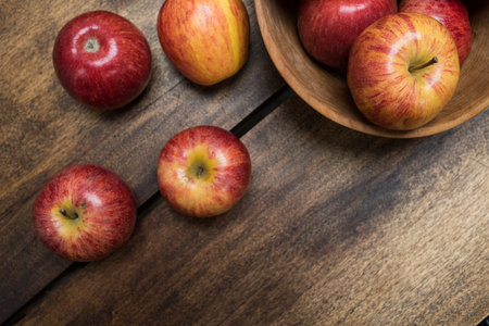 red apples on wooden background - arrangement of fruits