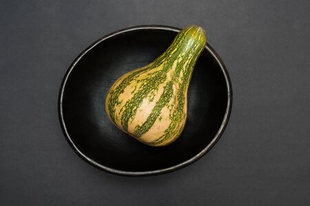 pumpkin in a bowl - studio shot on black background from aboveの写真素材