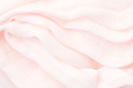 pink linen - close up of wrinkled textile - bright light backgroundの写真素材
