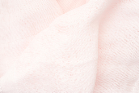 pink linen - close up of wrinkled textile - bright light backgroundの写真素材